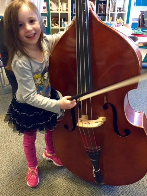 Kindergarteners explore musical instruments to make sound.