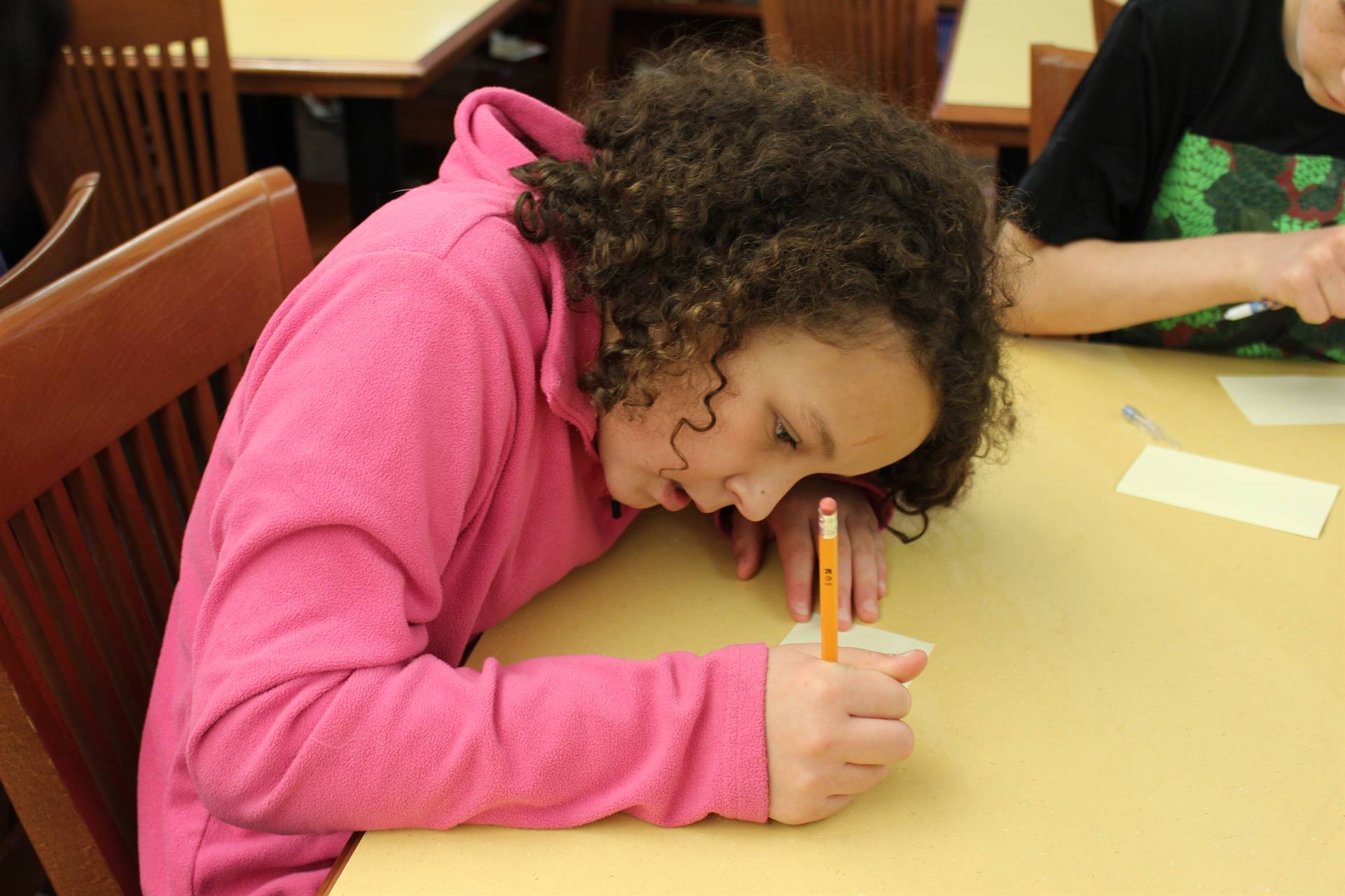 Photo of McIntyre Elementary Student Drafting a Happy Note for Friendship Friday