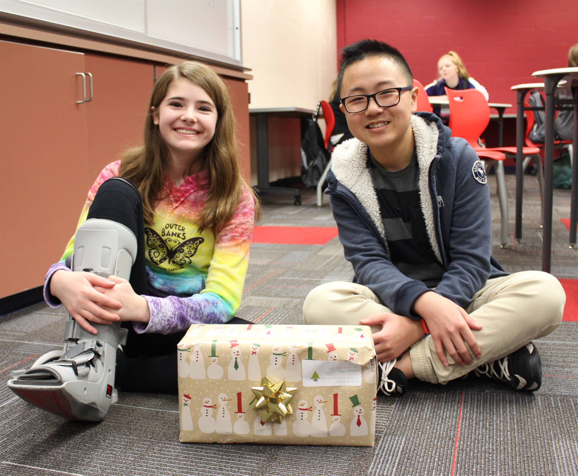 Middle School Service Club Members Wrapping Presents