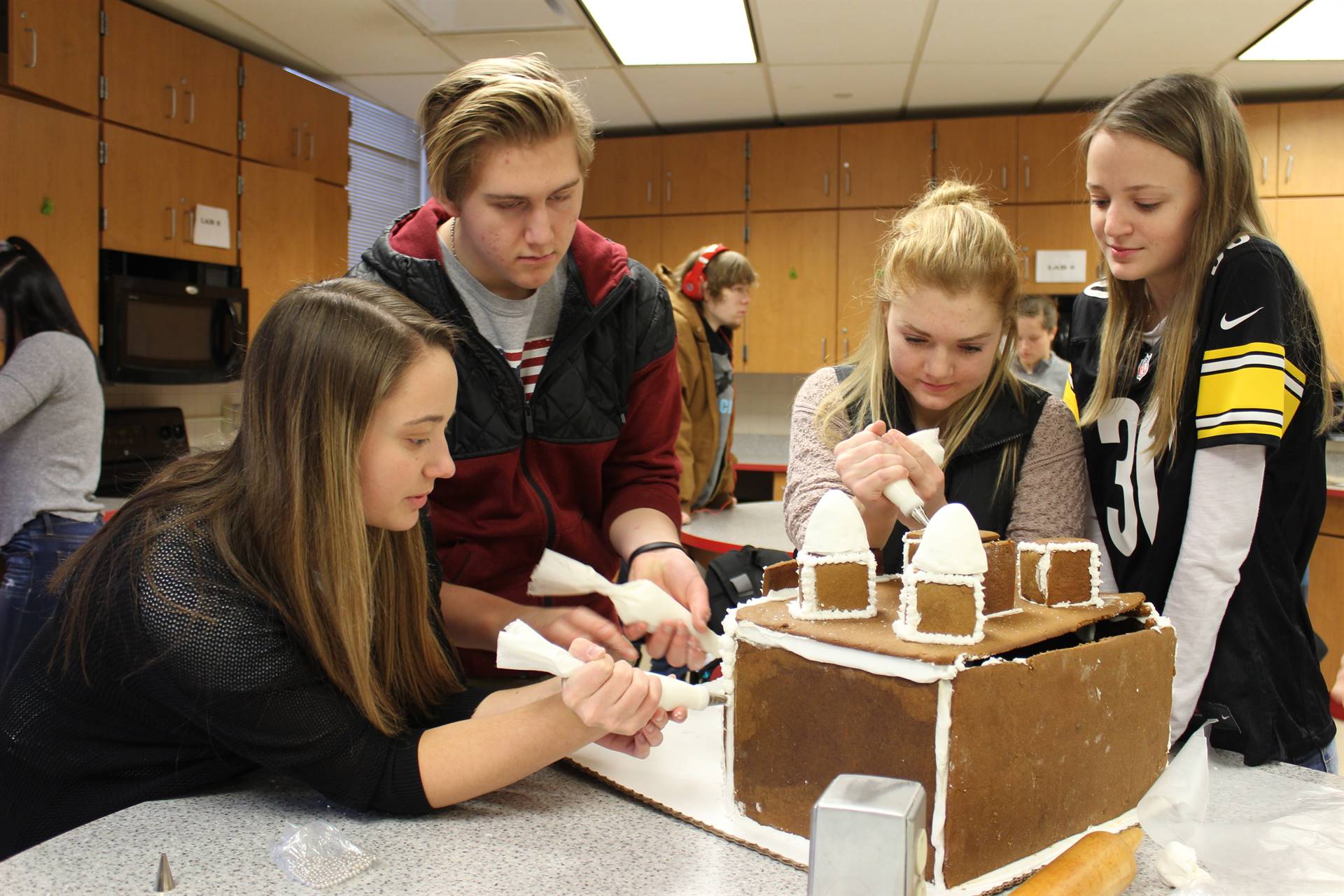 High School Students Decorate Gingerbread Houses