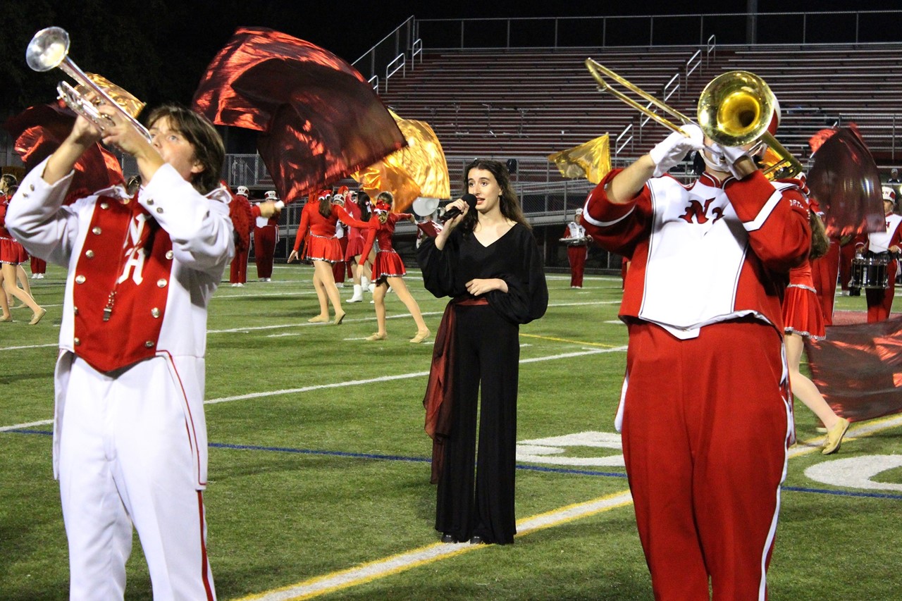 Senior Beth Satariano sings with the marching band