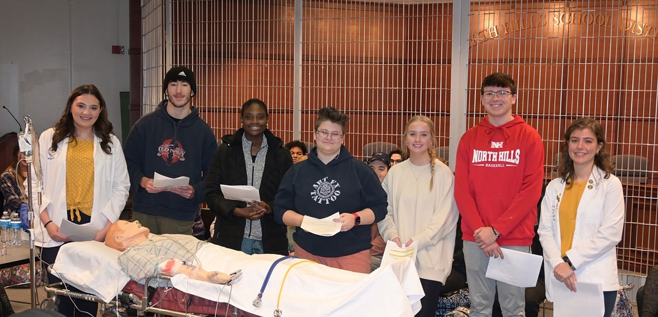 Pitt Pharmacy and North Hills students pose with robotic patient simulator