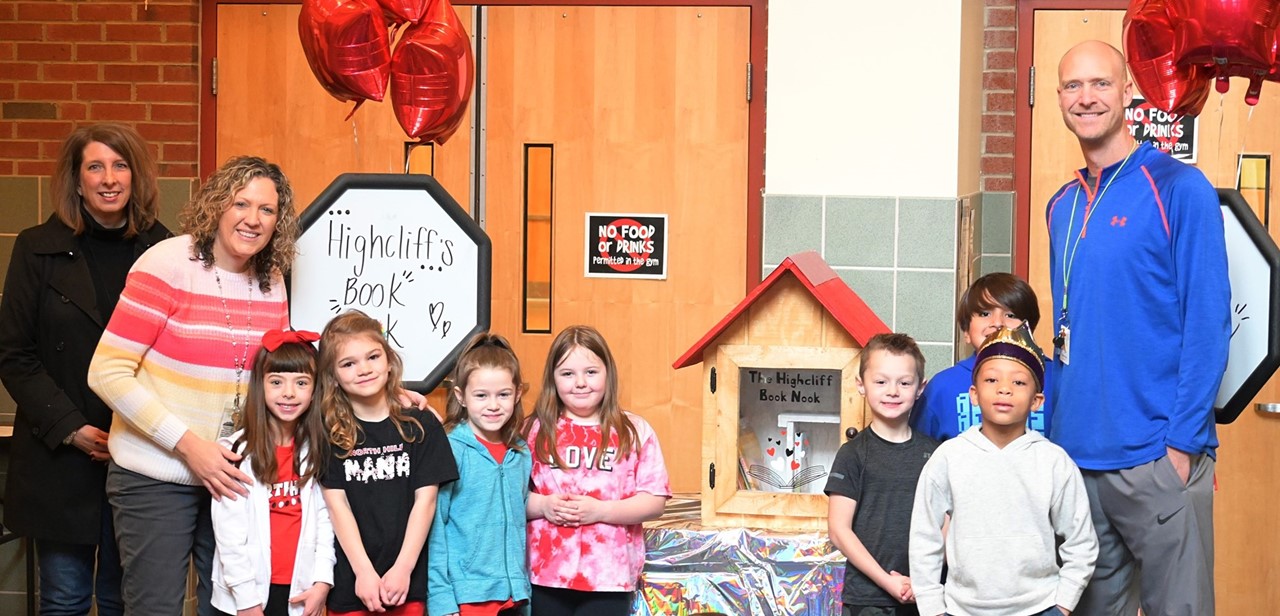 Students and teachers in front of Book Nook after ribbon cutting